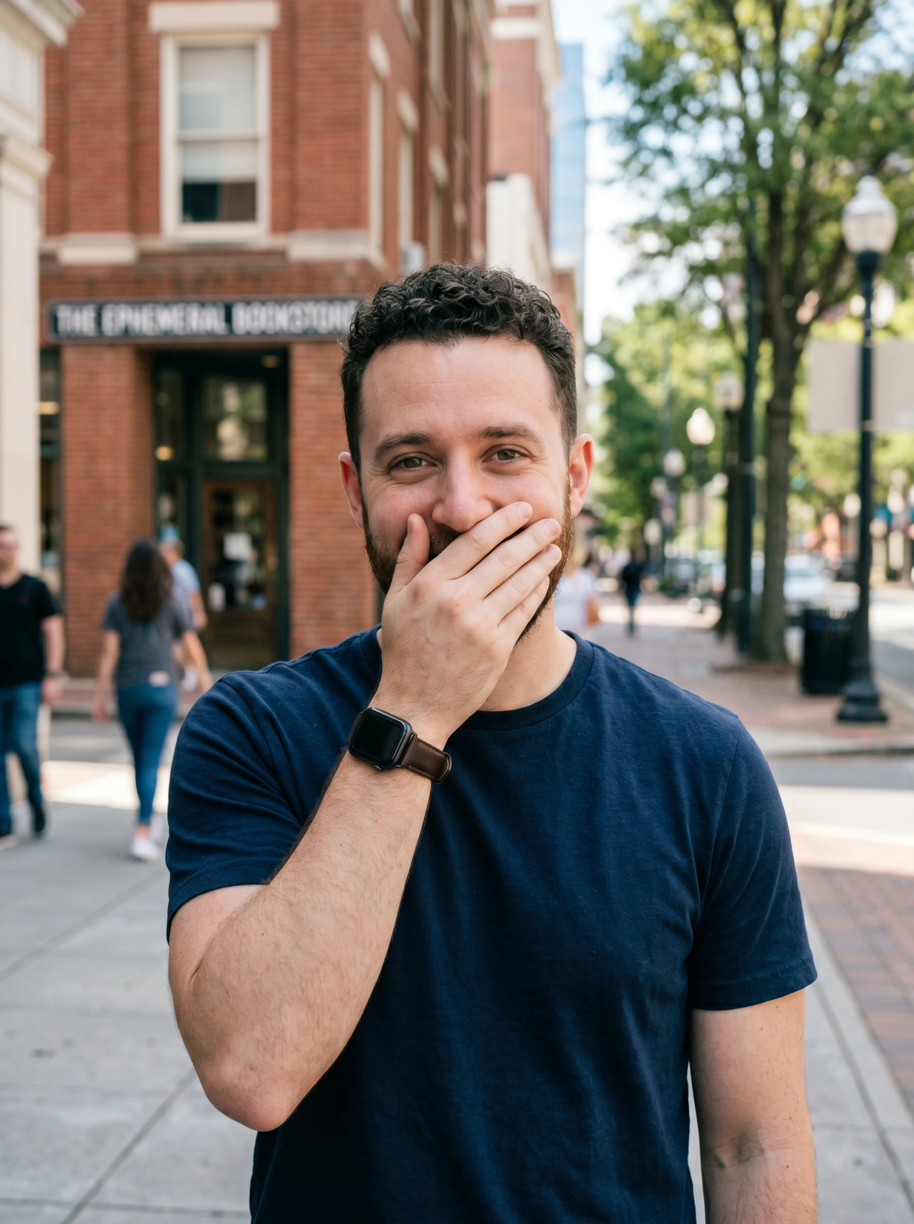 man covering his smile
