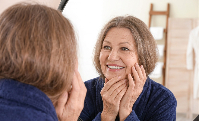 Senior woman admiring her smile