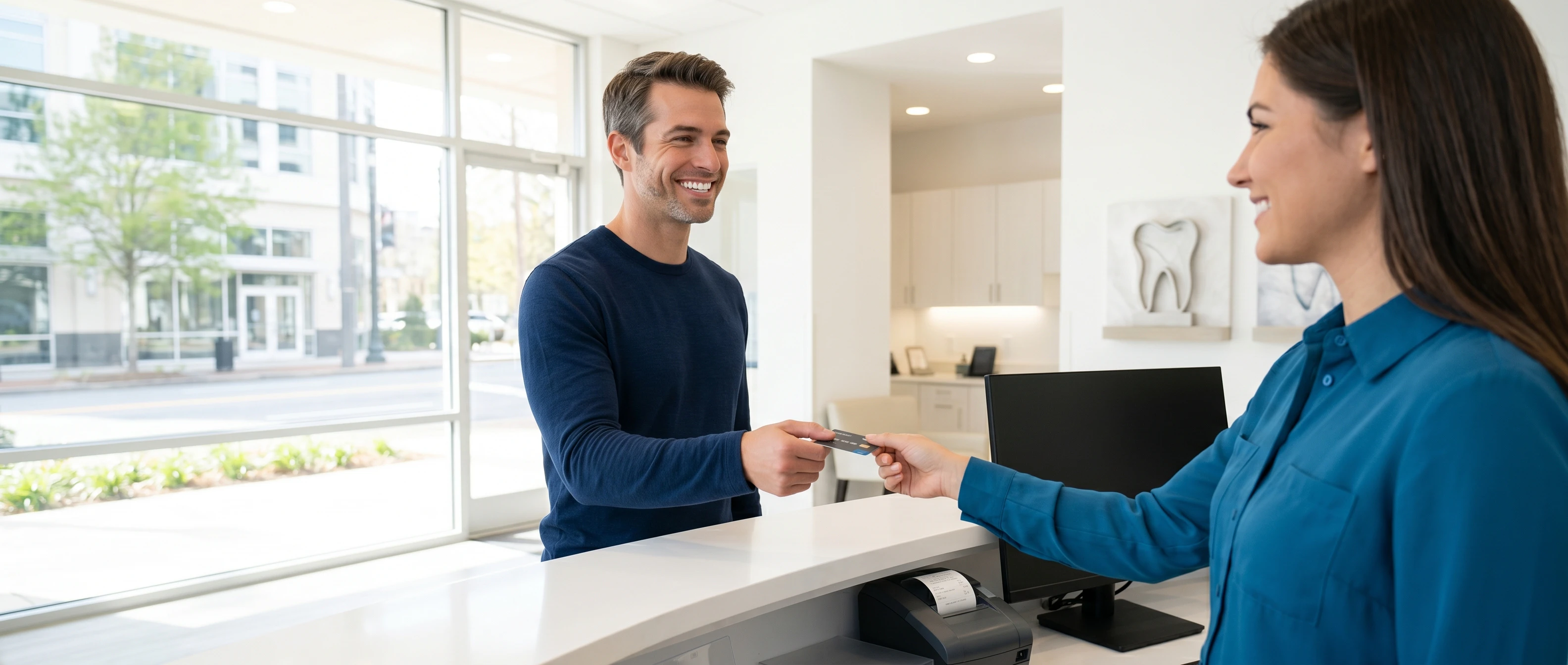man paying for dental service