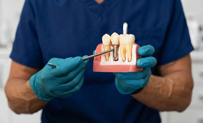 dentist pointing to an implant-supported crown
