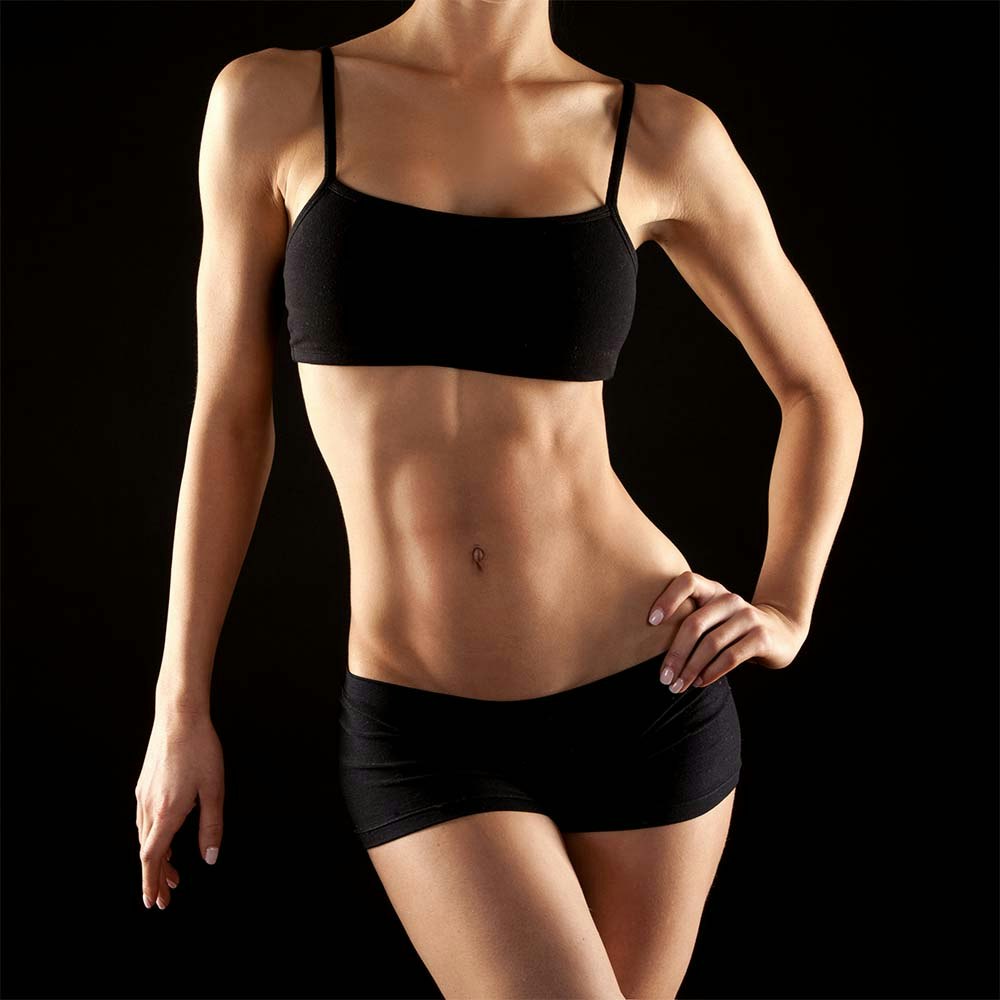 Thin woman in a sports bra and spandex shorts