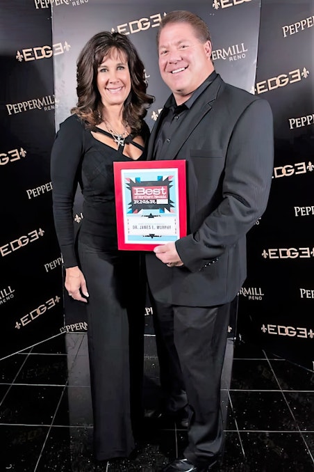 Dr. Murphy and his wife holding a 