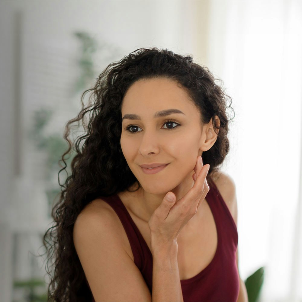 Woman admiring her face in the mirror