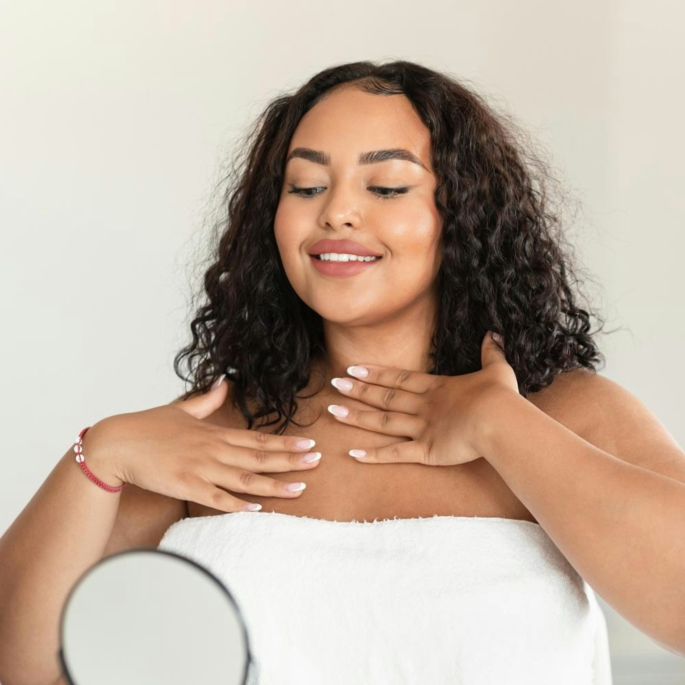 Woman admiring chest after laser tattoo removal