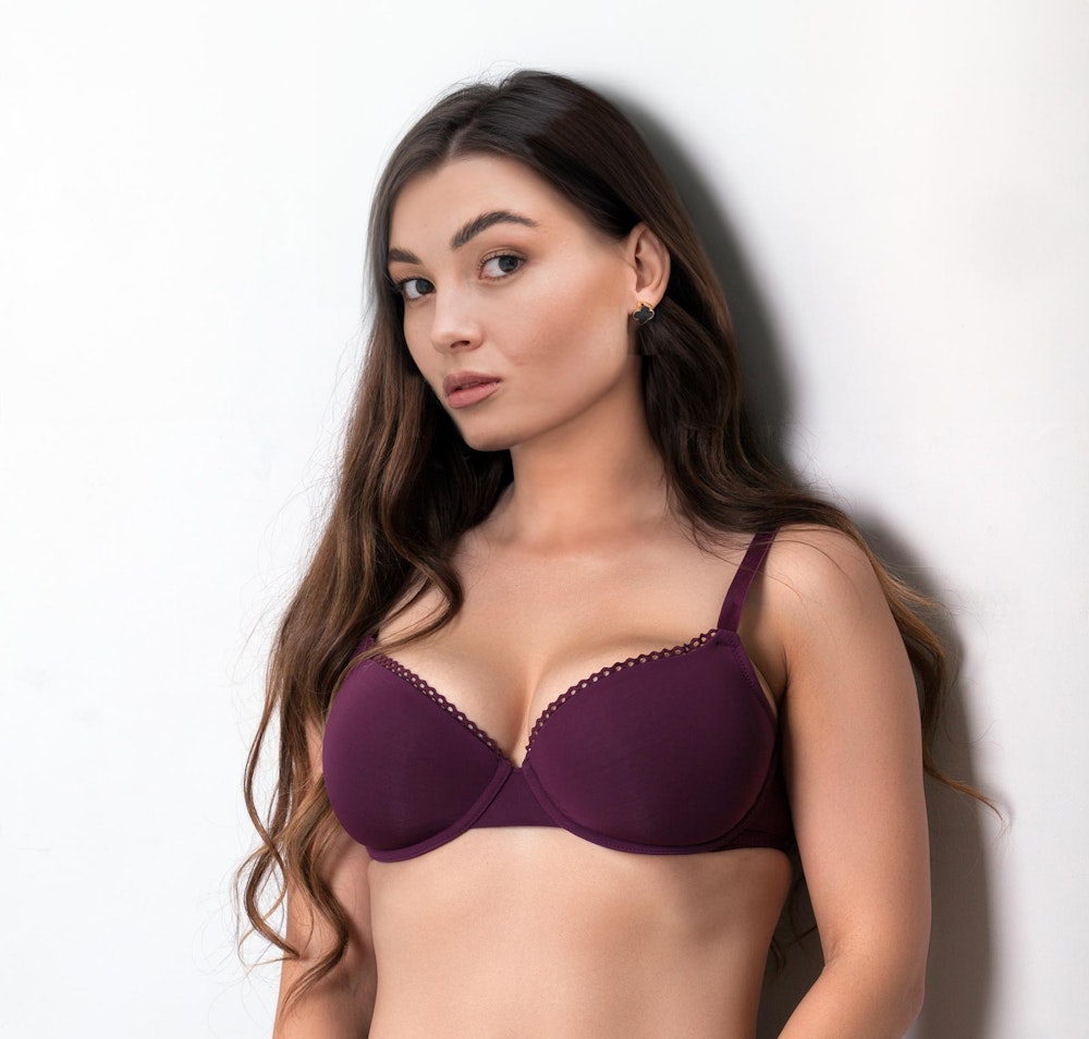 Woman in a bra after breast augmentation