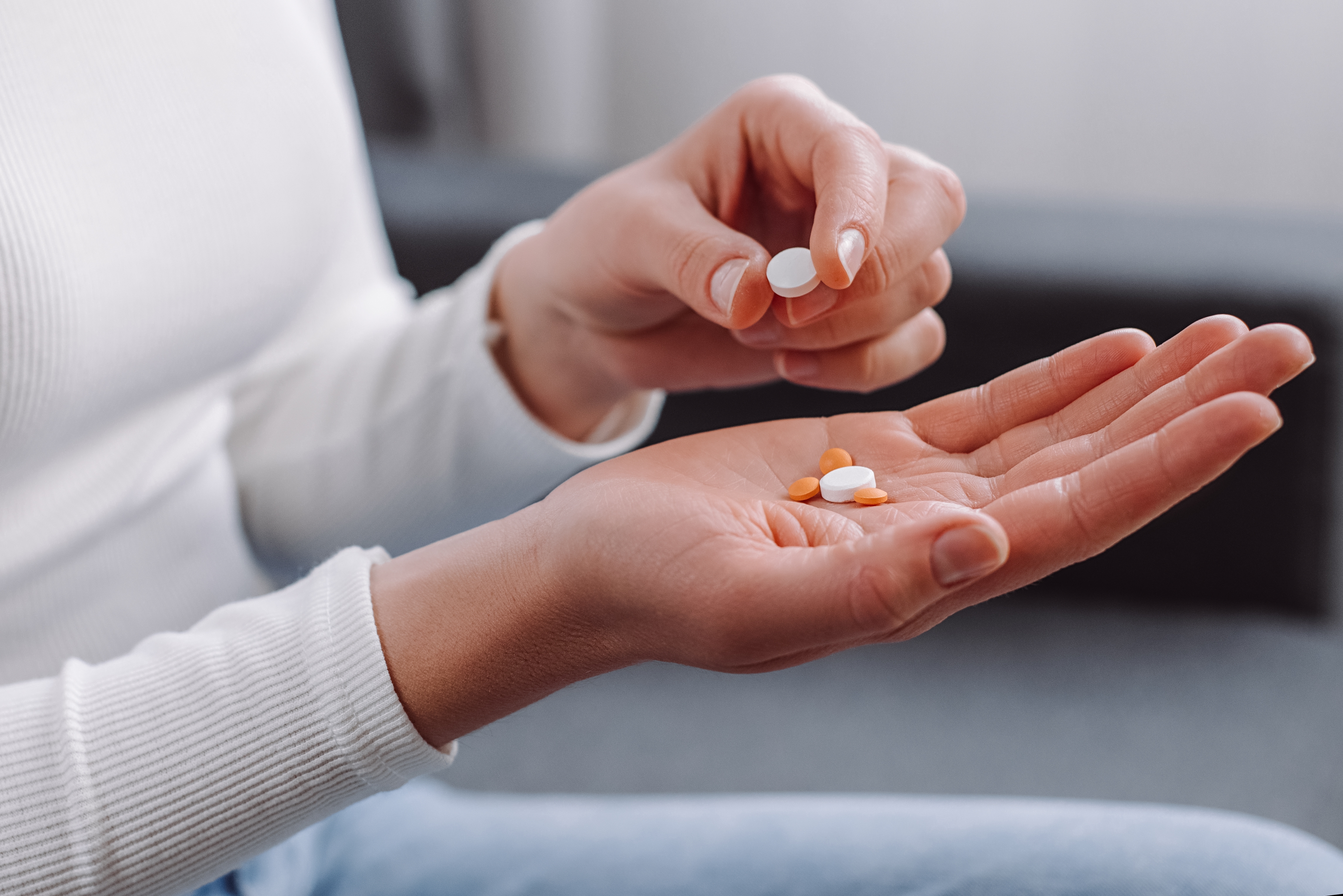 close-up of woman's hands holding pain medication