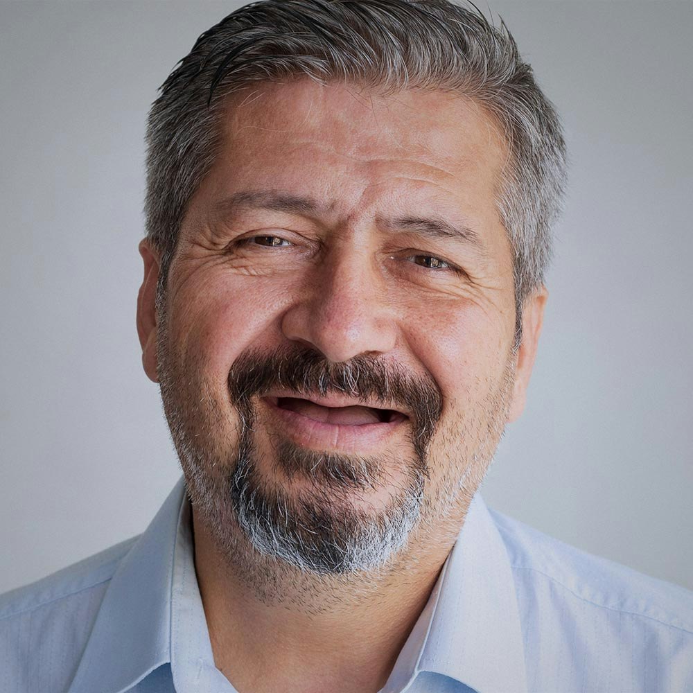 Older man without teeth smiling with mouth partially open