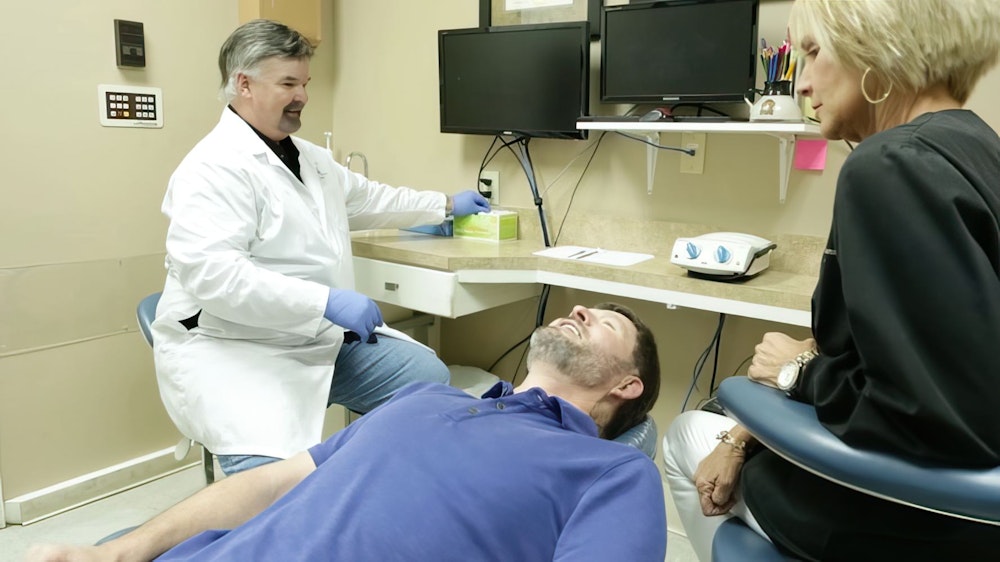 Dr. R. Clarke Stewart with patient and hygienist