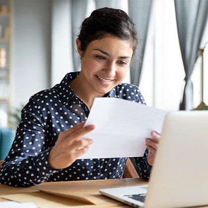 Excited woman considering BOTOX looking at paperwork