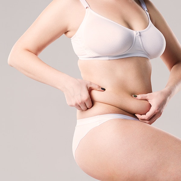 woman holding excess stomach skin