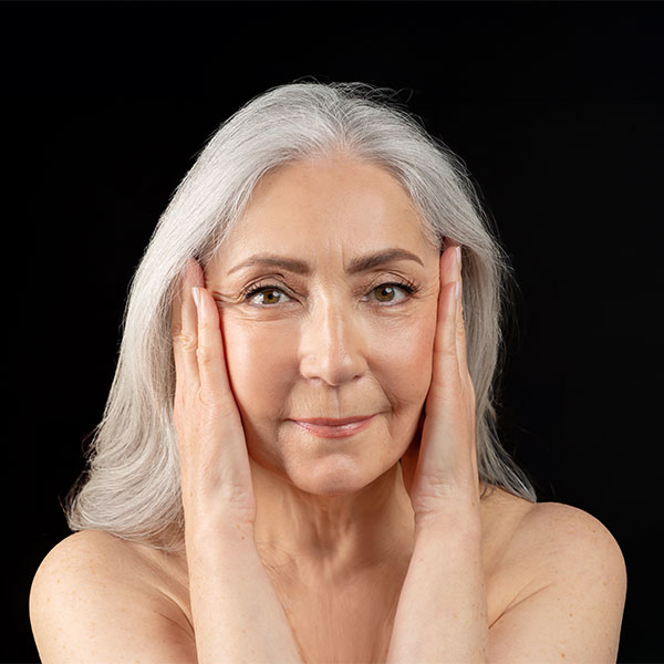 Close up of older woman's face with very few wrinkles