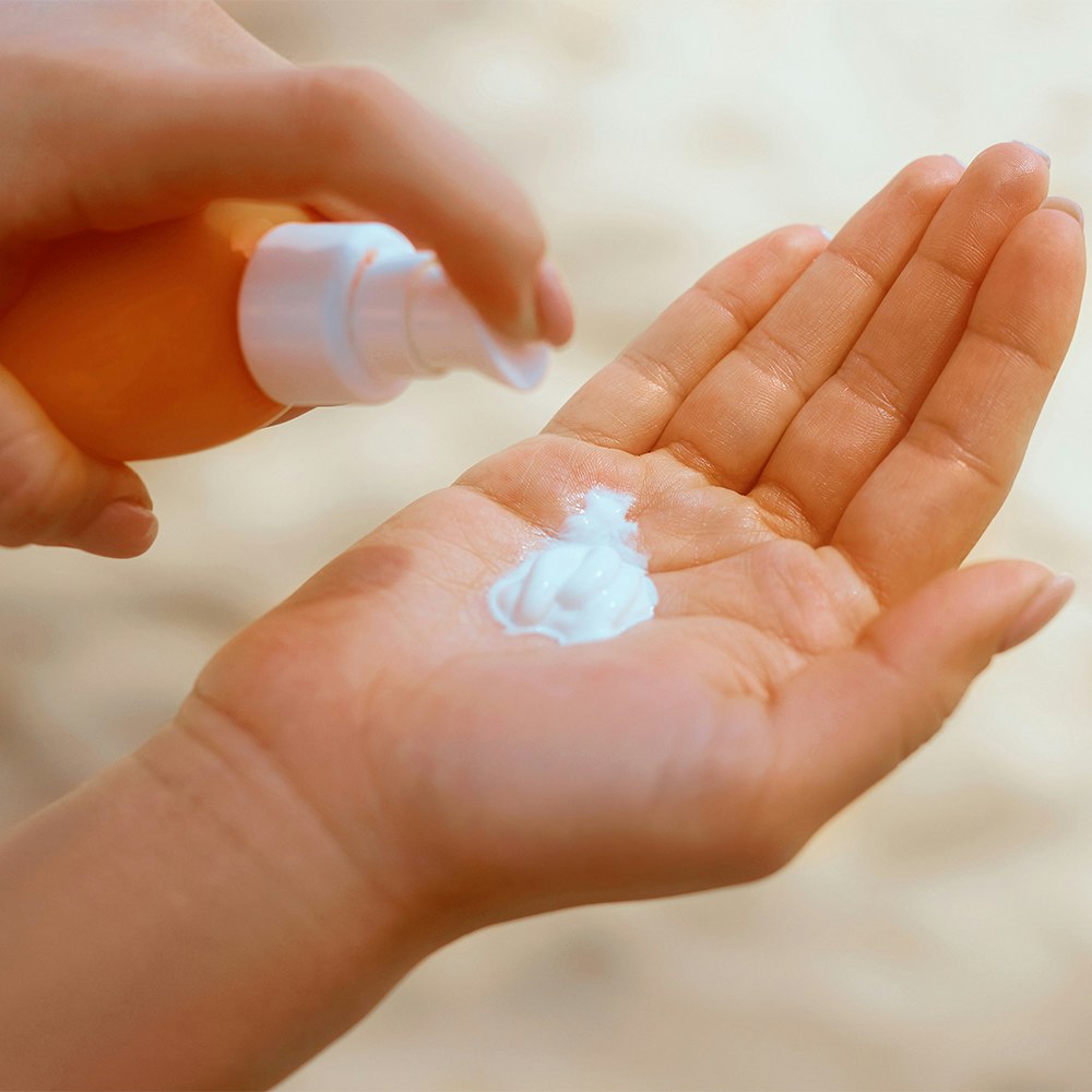 a woman using sunblock
