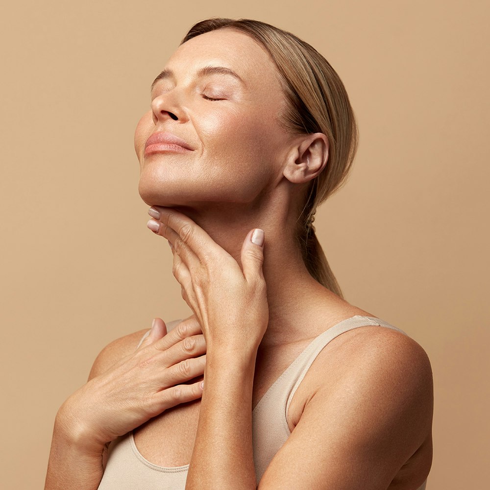 a woman touching her neck