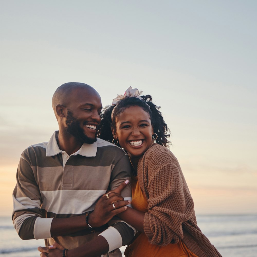 Couple smiling and walking down beach