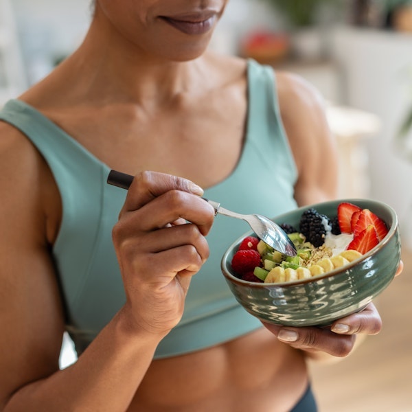 Close-up of woman eating a fruit bowl