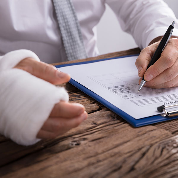 Man in cast filling out paperwork
