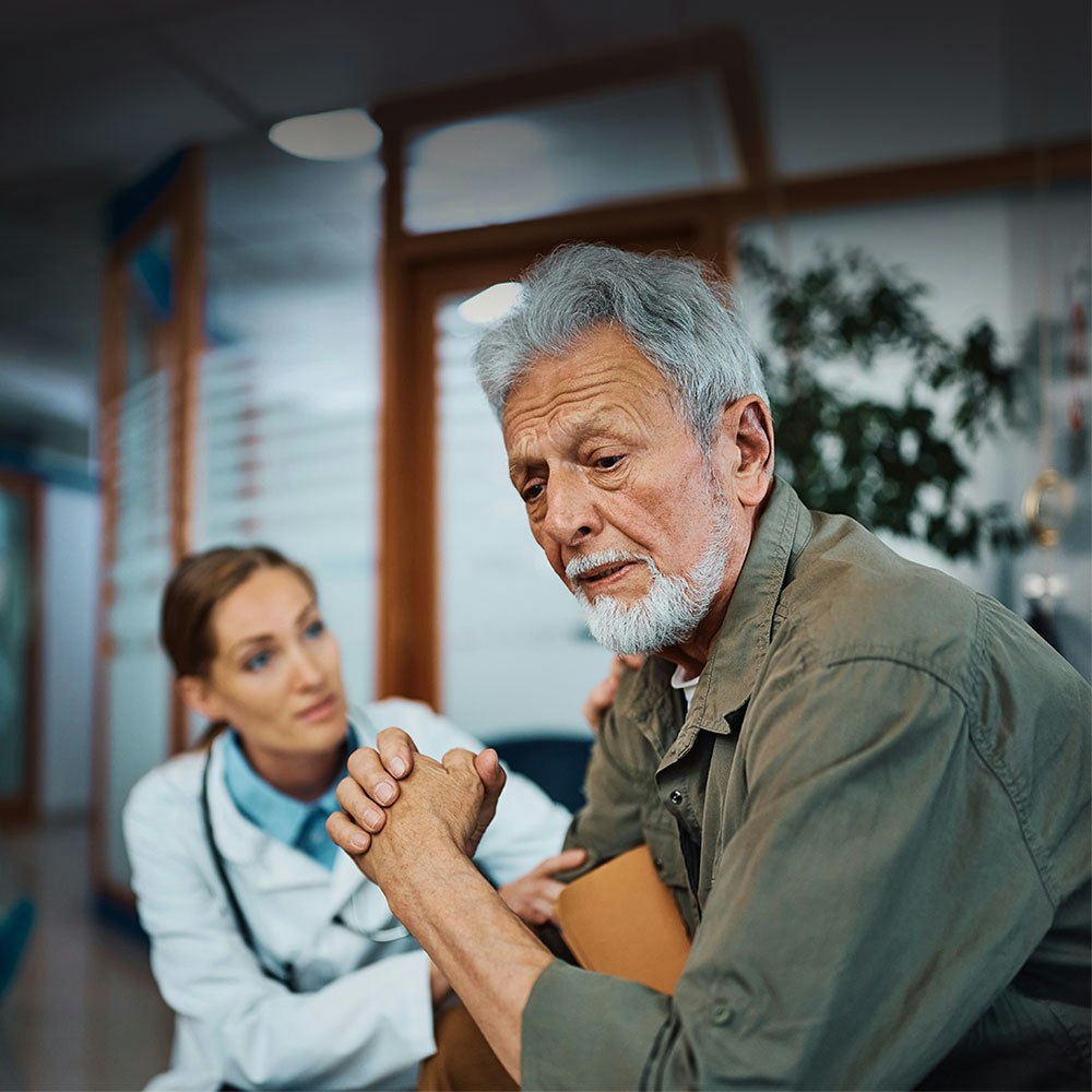 Doctor talking to a distressed man in the hospital
