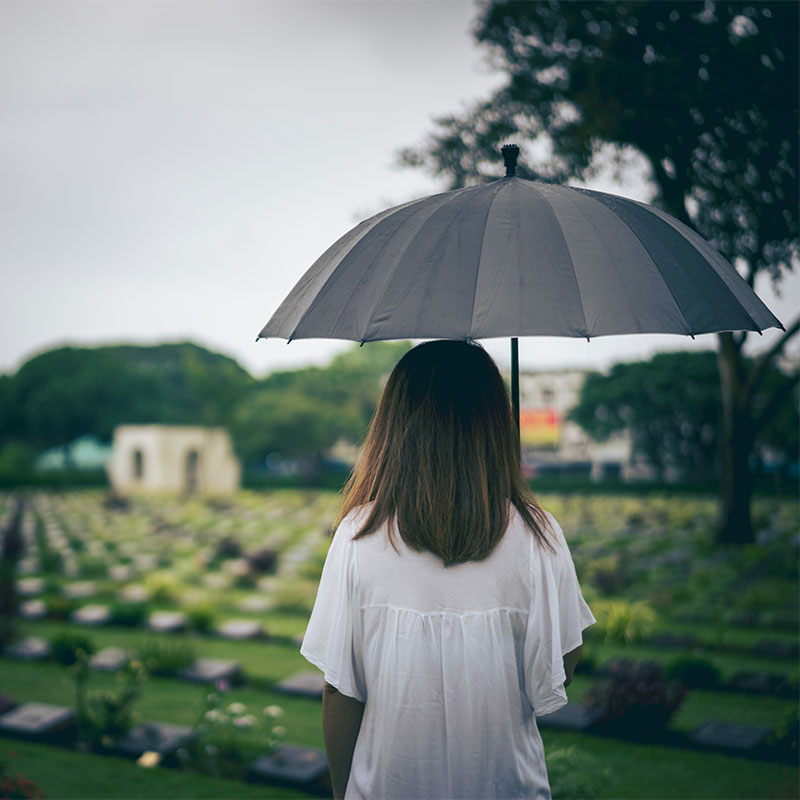 Girl standing in a graveyard
