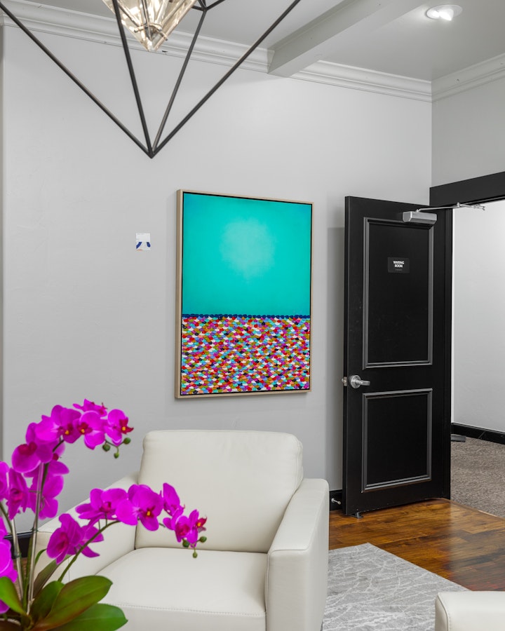 photo of a painting hanging near a door in our waiting room
