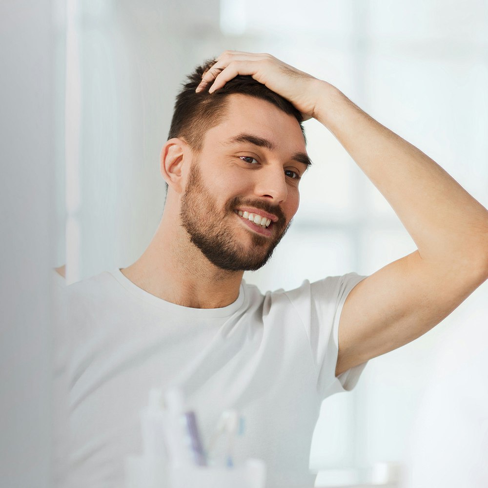 Man looking at hair