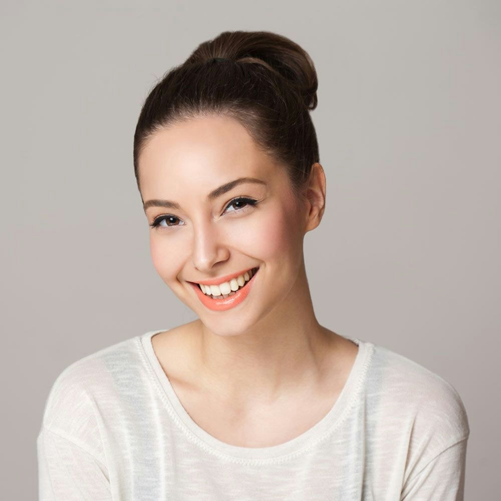 woman smiling after receiving cosmetic dentistry