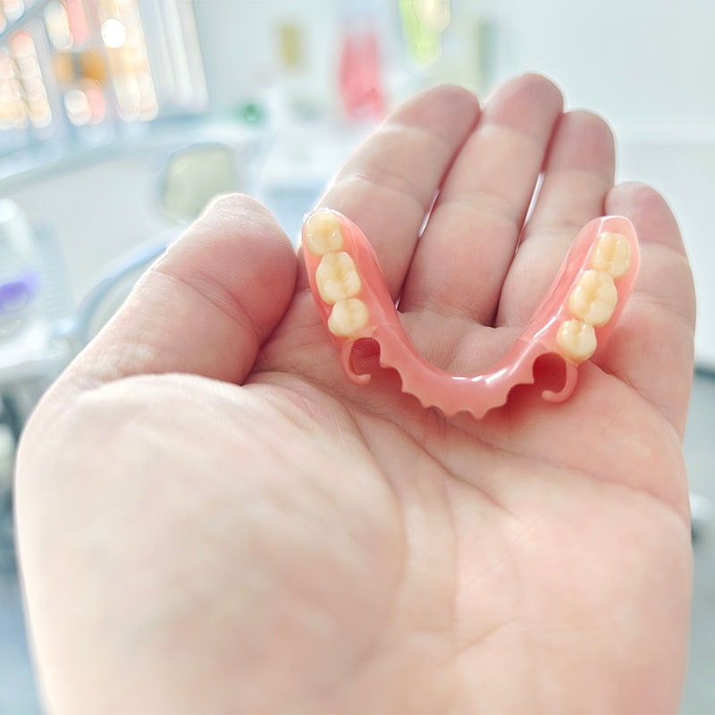 Person holding partial dentures