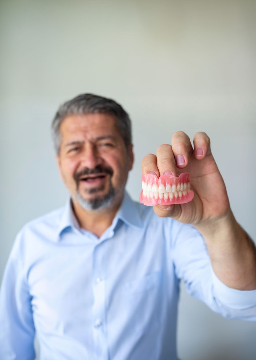 Man holding dentures