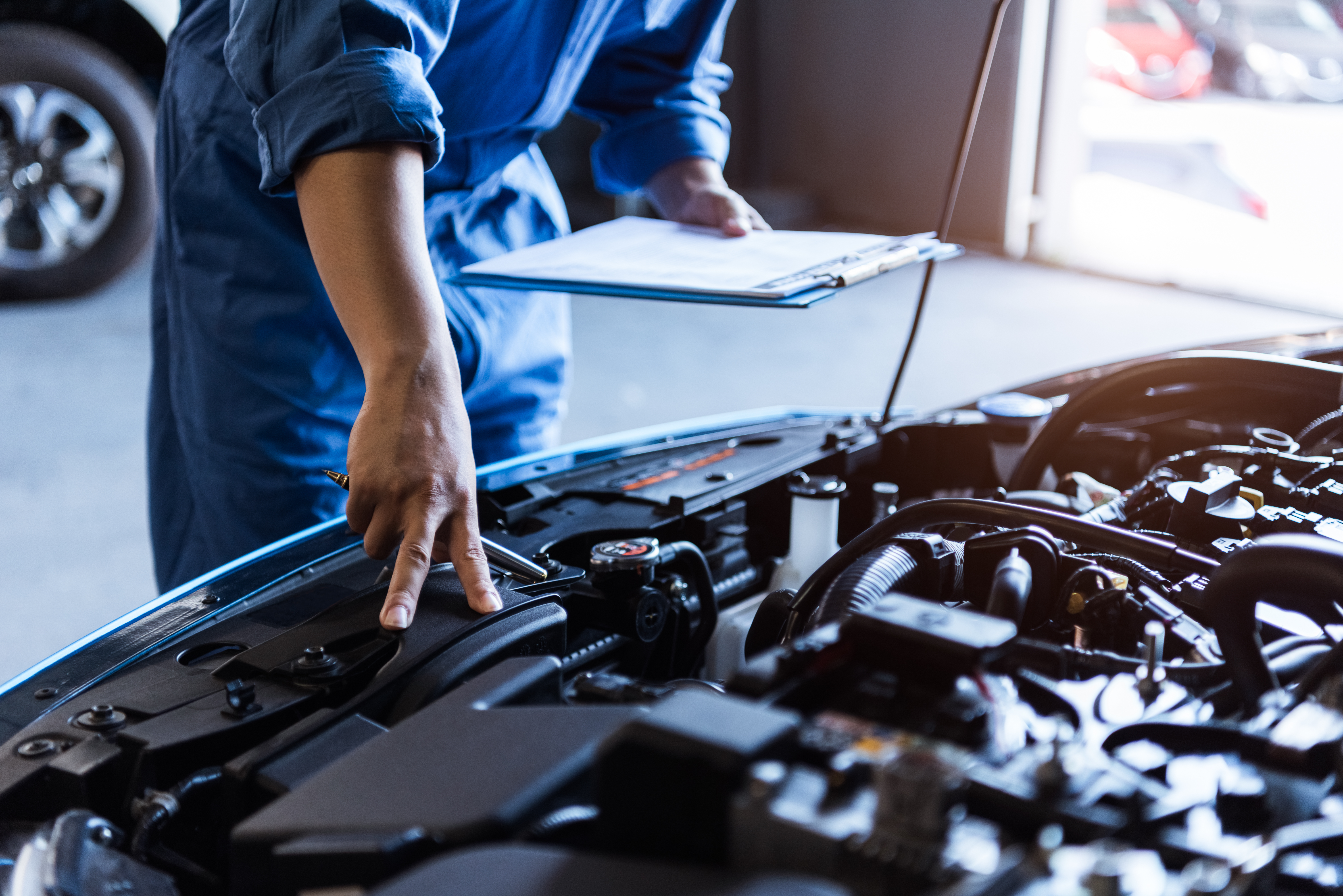 Mechanic looking over car