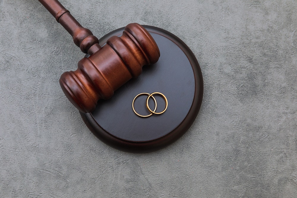 Gavel and wedding rings