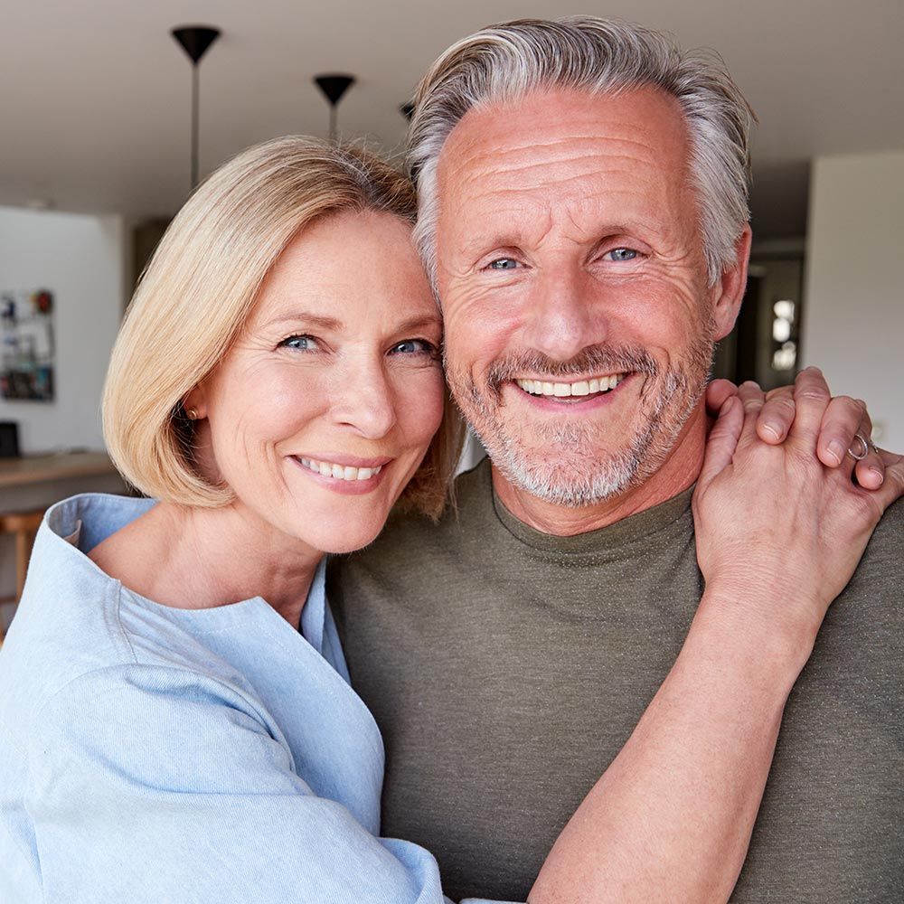 Couple smiling together in their home