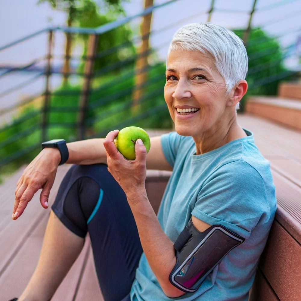 old woman about to bite into an apple