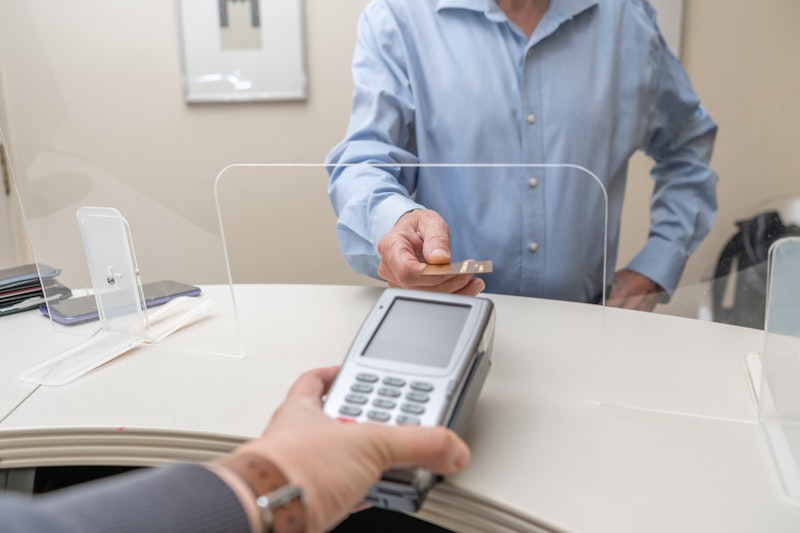 Man paying for dental care