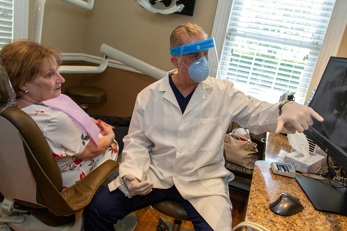 Dentist showing patient something on the computer