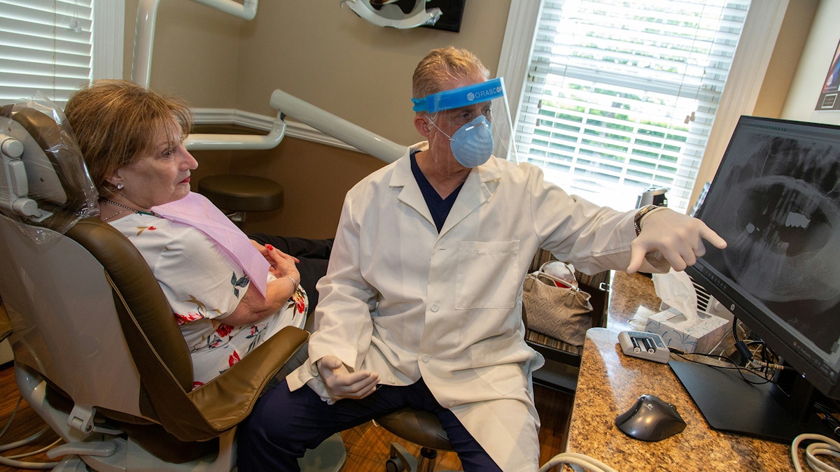 Dentist showing patient something on the computer