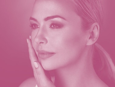 Beautiful woman holding hand to face