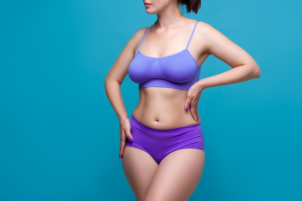 woman in bra and underwear showing midsection