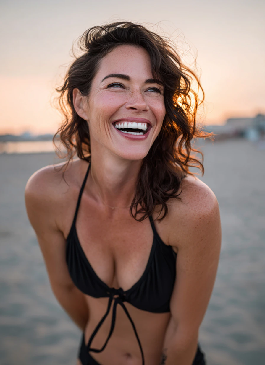toned woman laughing on the beach
