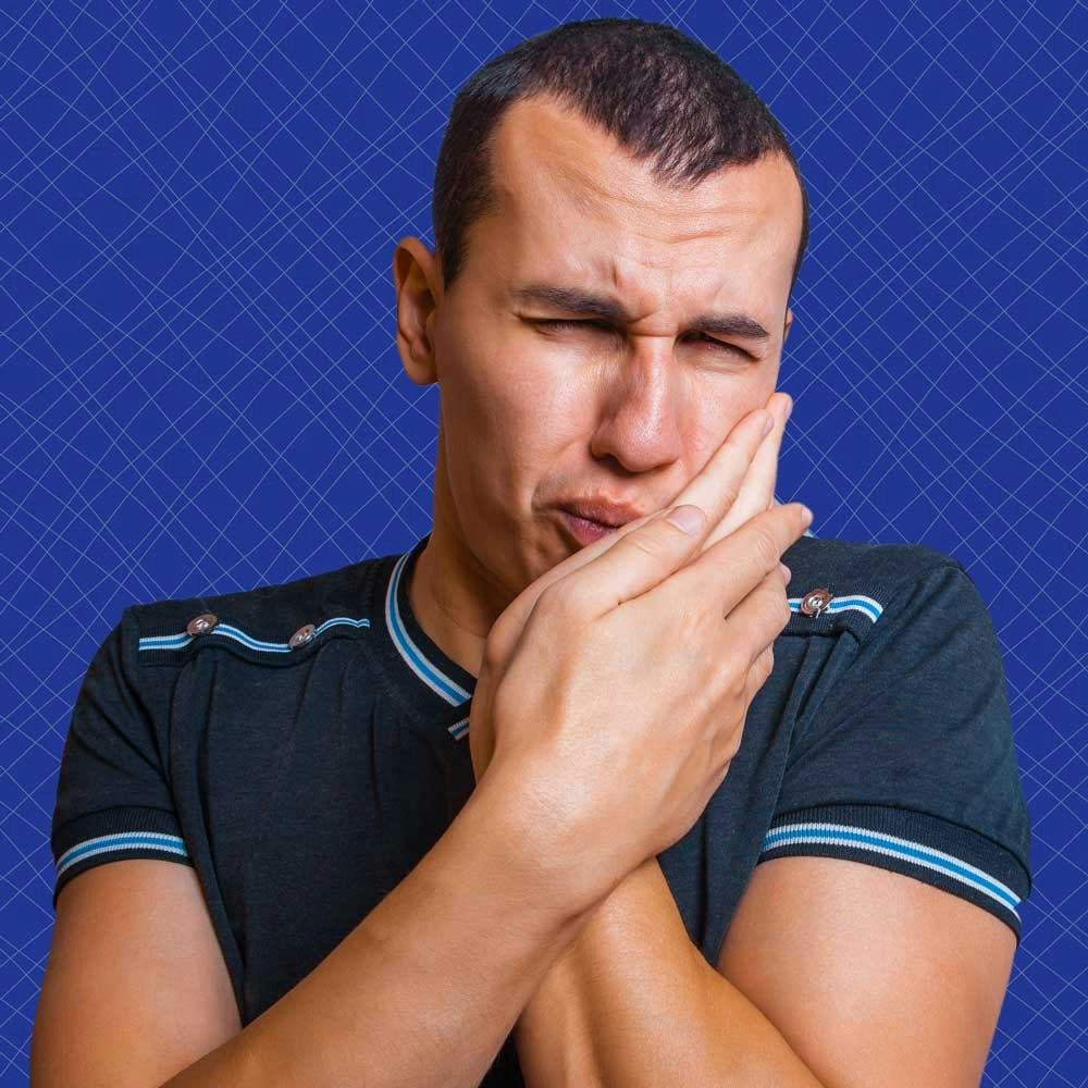 man holding his jaw in pain
