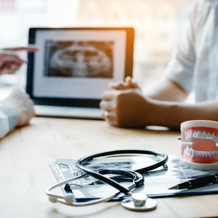 consultation with a patient at a desk
