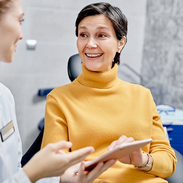 Happy woman in a denture consultation