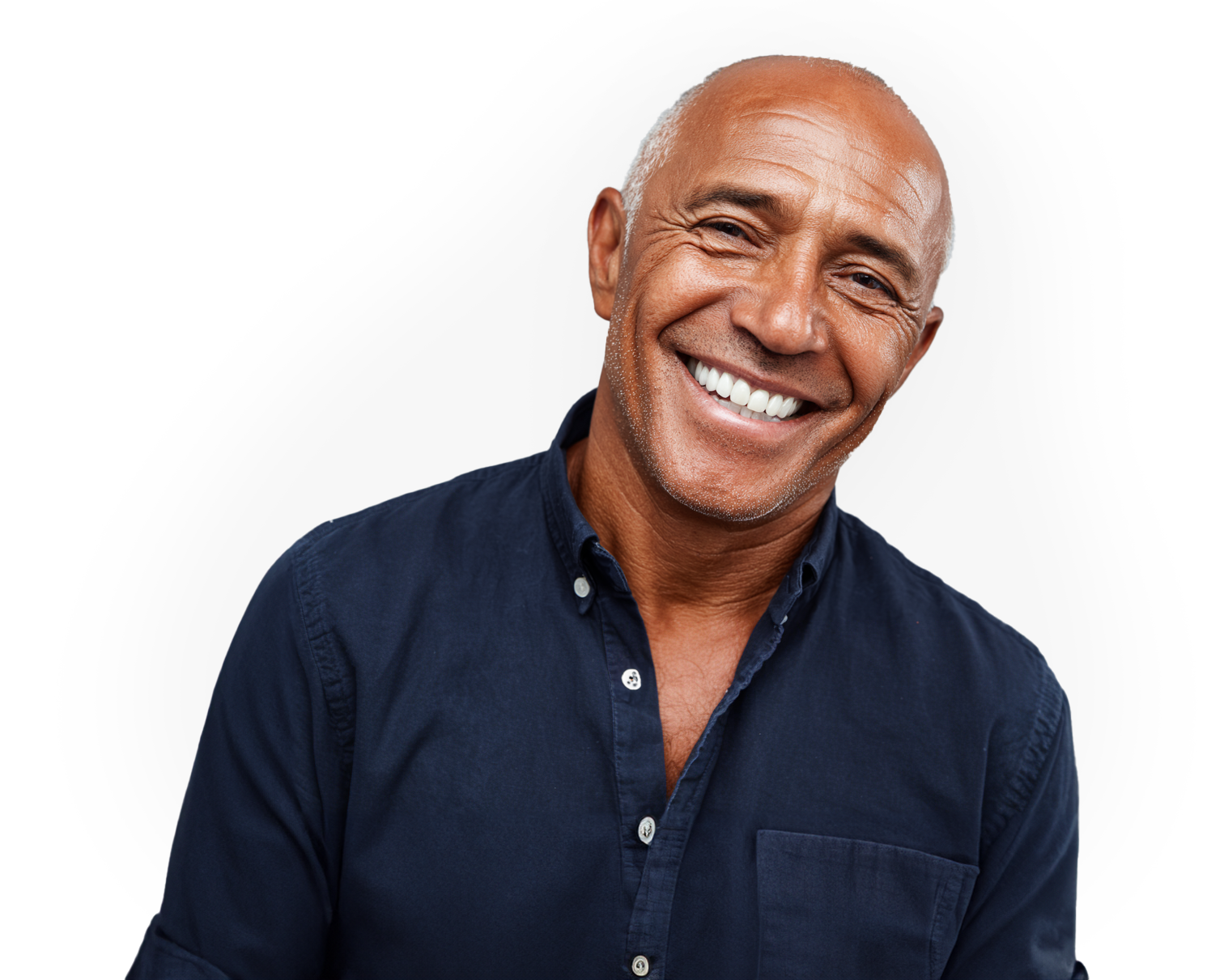 Bald man with tan skin smiling in a dark button-down shirt against a plain background