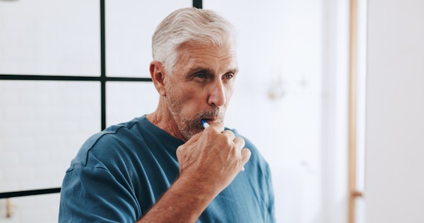 senior man brushing his teeth