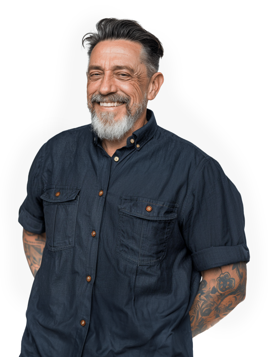 Smiling man with gray hair and beard wearing a dark button-down shirt with rolled sleeves