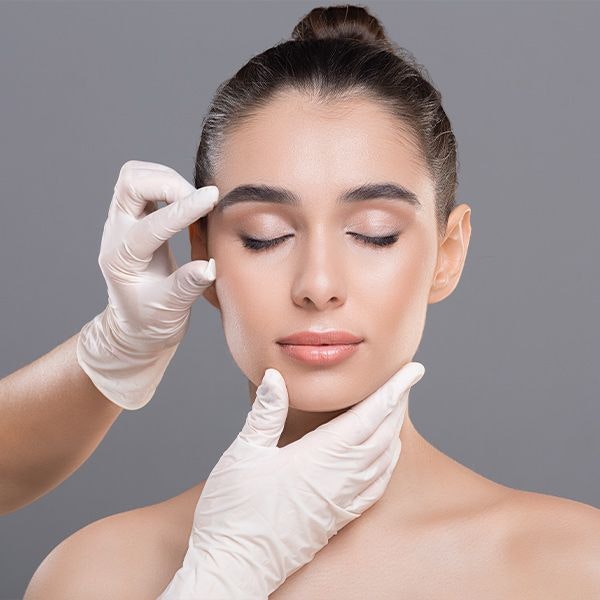 doctor examining a woman's face