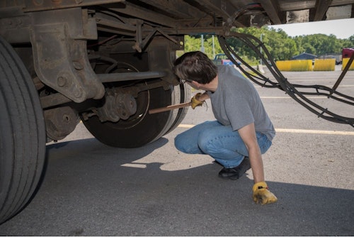 trucker checking tire