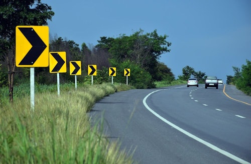 road signs indicating curve ahead