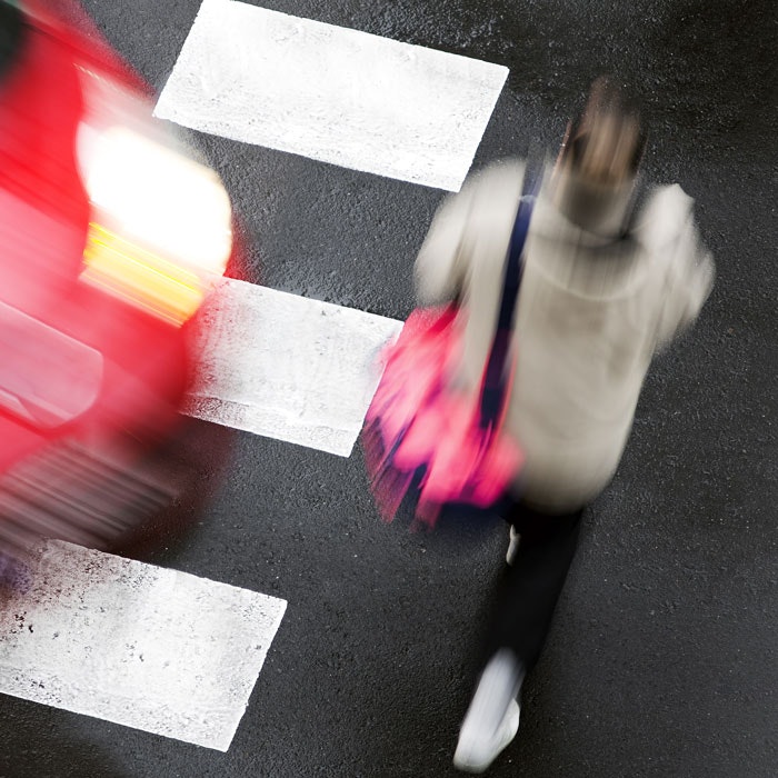 Pedestrian in a crosswalk about to be hit by a speeding car