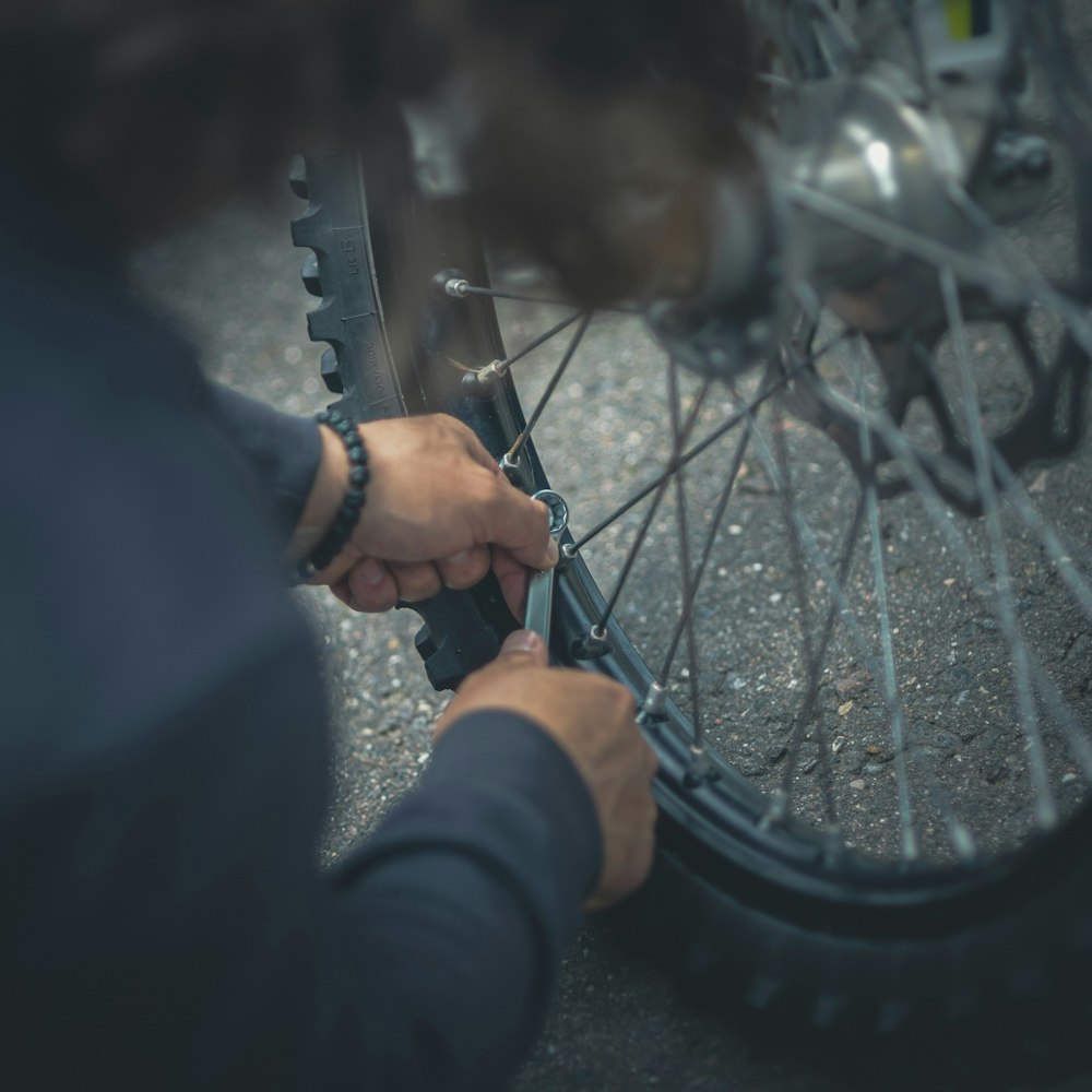 Person working on bike wheel