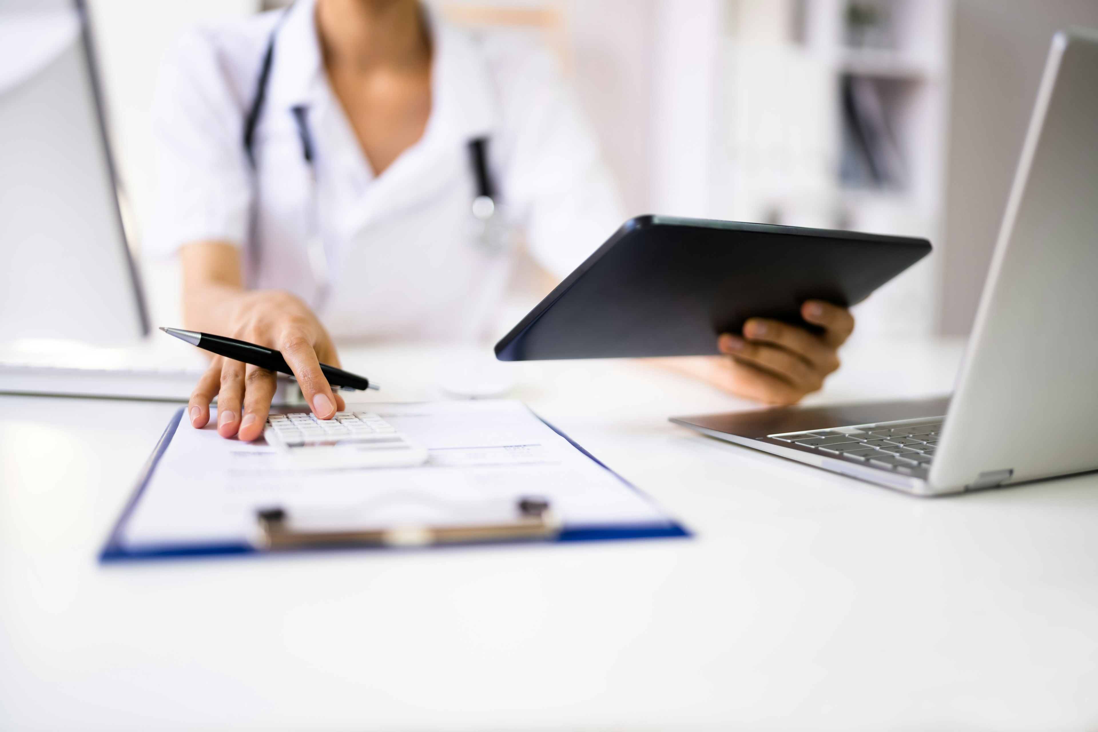 Medical professional filling out paperwork