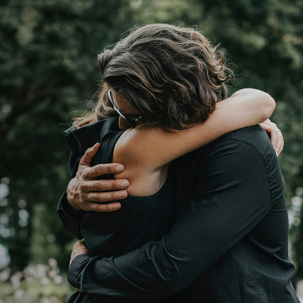 Couple dressed in black embracing
